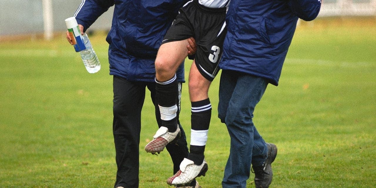 medics carrying an injured athlete